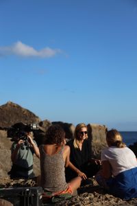 Mariana van Zeller sits with her best friend and cousin on the coast of Portugal. (National Geographic for Disney)