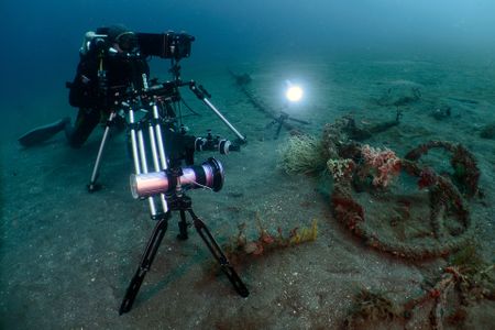Cinematographer Roger Munns sets up filming equipment on the sea floor to film a hairy frogfish lying in wait. (National Geographic/Jason Isley)