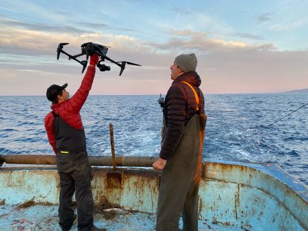 Alex Warham and Jacca Deeble launch a drone to film footage of an ocean trawler. (Credit: Silverback Films and Open Planet Studios/Alex Warham)