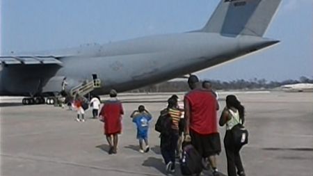 New Orleans residents board a plane to relocate following Hurricane Katrina. (Associated Press)