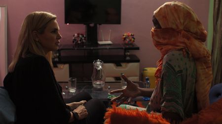Mariana sits with Sylvie, a pregnant surrogate mother in Kenya. (Photo credit: National Geographic)