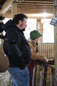 Charles Pol and Beth Pol stand outside of the merino sheep pen at Michigan Merinos and Happy Goat Lucky Ewe Fiber Farm. (National Geographic)