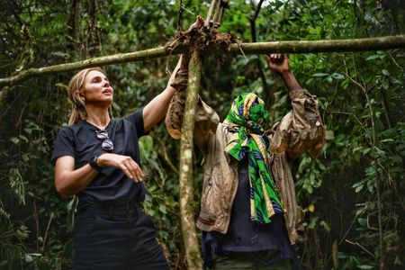 Mariana van Zeller watches as a pygmy poacher sets a trap in the forest. (National Geographic for Disney)