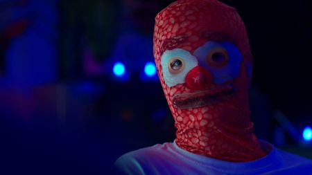Mariana interviews 'Sparkles' who wears a bacon, eggs and beans mask. (National Geographic)