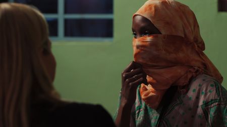 Mariana sits with Sylvie, a pregnant surrogate mother in Kenya. (Photo credit: National Geographic)