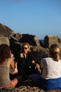 Mariana van Zeller sits with her best friend and cousin on the coast of Portugal. (National Geographic for Disney)