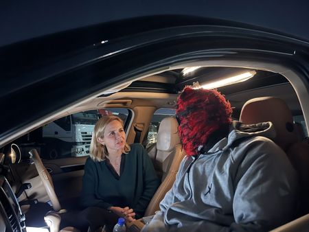 Mariana van Zeller talks to Chris in a car. (National Geographic for Disney)