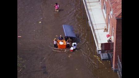 Residents of New Orleans navigate flood waters after Hurricane Katrina. (Pond5)