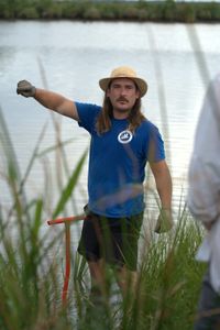Gardner Goodall, Native Plants Program Coordinator from the Coalition to Restore Coastal Louisiana, explaining the sea grass planting task to Anthony Mackie and volunteers. (National Geographic/Brian Roedel)