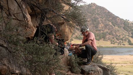 Cinematographer Nick Kraus films Conrad Anker unpacking his backpack.  (National Geographic/Elena Gaby)