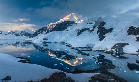 The Spirit of Sydney sails through an icy inlet surrounded by small icebergs. (National Geographic/Bertie Gregory)