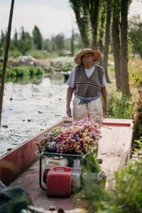 A local flower farmer who works on the chinampas (floating gardens) in Xochimilco stands on his boat. (National Geographic/Karl Davies)
