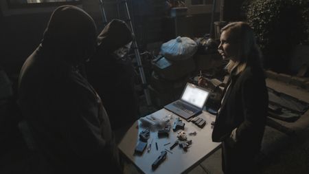 Mariana van Zeller holds a USB during interview with Tiny and Flaco. (Credit: National Geographic)