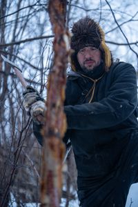 Chevie Roach gathers branches to build a blind during the migratory water fowl hunting season. (BBC Studios Reality Productions/Jayce Kolinski)