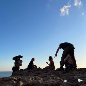 Mariana van Zeller sits with her best friend and cousin on the coast of Portugal. (National Geographic for Disney)