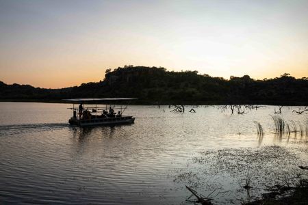 The filming barge heads out onto the lake at sunrise. (National Geographic for Disney/Alex Minton)