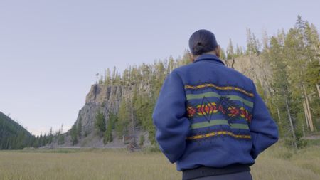 Dr. Shane Doyle looking at Obsidian Cliff.  (National Geographic)