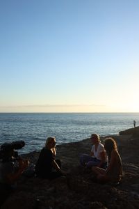 Mariana van Zeller sits with her best friend and cousin on the coast of Portugal. (National Geographic for Disney)