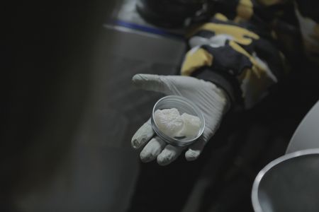 Sai holding pure MDMA crystals. (Credit: National Geographic)
