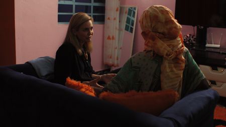 Mariana sits with Sylvie, a pregnant surrogate mother in Kenya. (Photo credit: National Geographic)