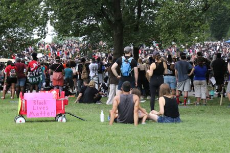 Crowd of marchers with Black Lives Matter sign on a red cart at the 2020 March on Washington.  (National Geographic/Drew Jones)