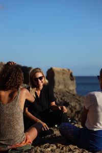 Mariana van Zeller sits with her best friend and cousin on the coast of Portugal. (National Geographic for Disney)