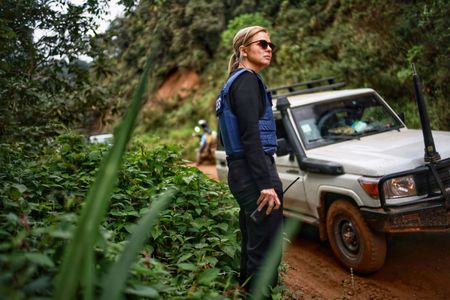 Mariana van Zeller waits as the team tries to clear a vehicle from the deep mud in the forest. (National Geographic for Disney)