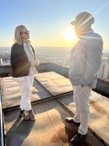 Mariana van Zeller and Ben discuss the world of scamming while on a rooftop in Johannesburg. (National Geographic for Disney)