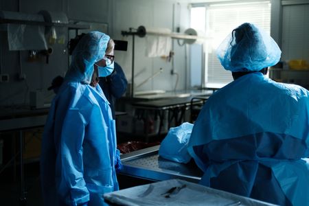 Mariana van Zeller watches as Hayley carves transplant material from donor bodies. (National Geographic for Disney)