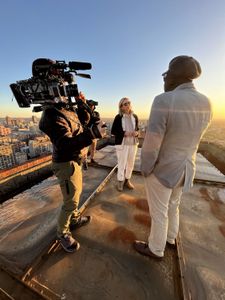 Mariana van Zeller and Ben discuss the world of scamming while on a rooftop in Johannesburg. (National Geographic for Disney)