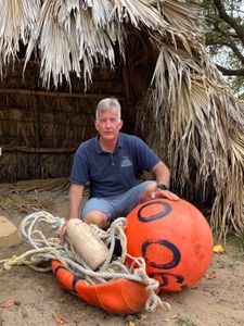 Whale Rescue Expert Ed Lyman with discarded fishing gear cut free from an entangled humpback whale. (National Geographic for Disney/Rory Dormer)