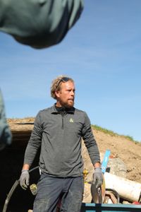 Ben Reinhold stands in front of the earth-sheltered sheep hut he is working on for the Pol family's farm. (National Geographic )