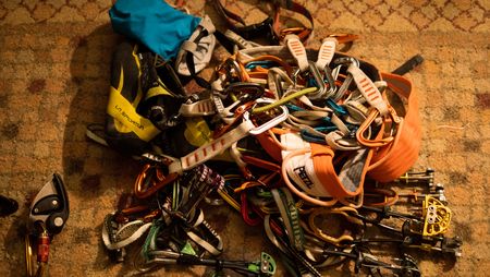 Conrad Anker's gear spread out on the floor of the gear room.  (National Geographic/Elena Gaby)