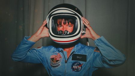 NASA Astronaut Sally Ride posing with her space helmet during her time in training as a mission specialist for NASA's STS-7 spaceflight. (Credit: NASA)