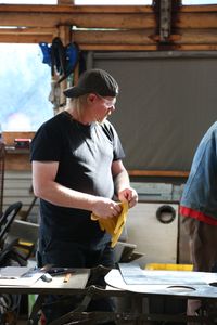 With the help of his neighbor, David Squibb constructs a new fairlead for his skiff. (National Geographic/Wayne Moss)