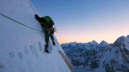 Conrad Anker climbs a wall covered in ice on the face of Lunag Ri, in the Himalayas.  (Mandatory credit: Red Bull Media House)