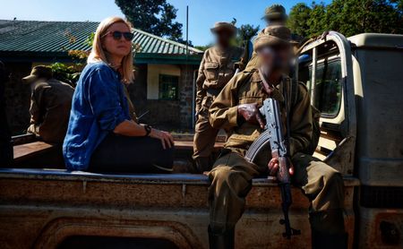 Mariana van Zeller sits with rangers in the Democratic Republic of the Congo. (National Geographic for Disney)