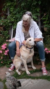 Jenni Lowe Anker pets her dog in the garden.   (National Geographic/Elena Gaby)