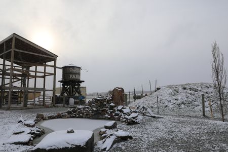 Snow falls on the Pol family farm's garden and pond. (National Geographic)