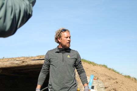Ben Reinhold stands in front of the Pol family farm's soon-to-be earth-sheltered sheep hut. (National Geographic )