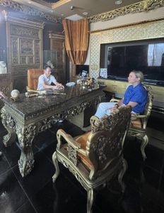 Mariana Van Zeller sits with Johnny Dang in his eccentrically decorated office. (National Geographic)